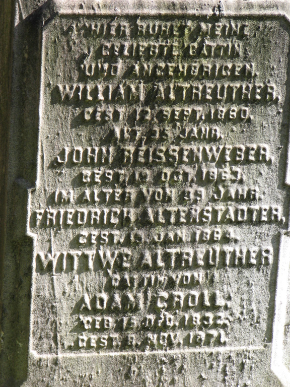Old worn gravestone with five names